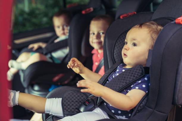 Three children in car safety seat