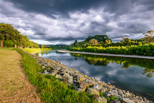 On the banks of the river Manawatu in Palmerston North New Zealand under dramatic skies