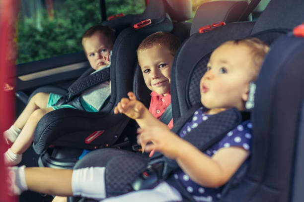 istock Three children in car safety seat 945565748
