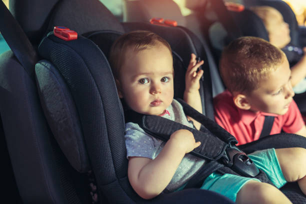 istock Three children in car safety seat 945567058