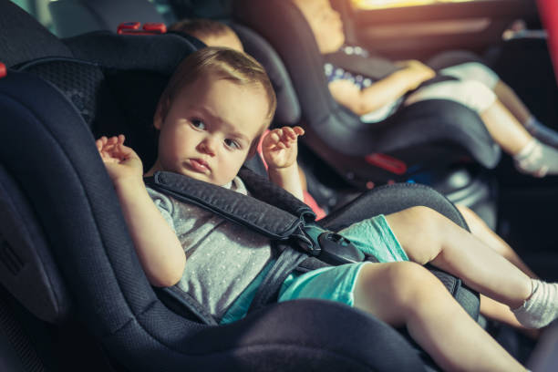 istock Three children in car safety seat 945570214