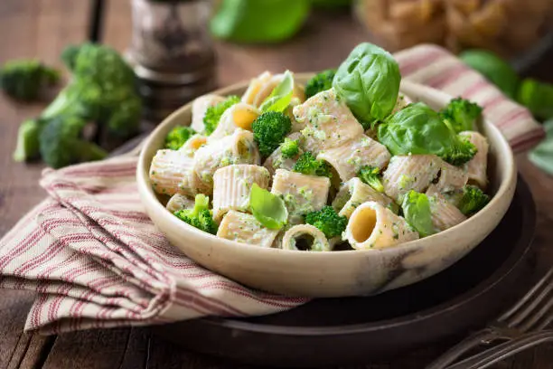 Vegetarian whole grain pasta with creamy broccoli sauce and basil