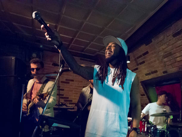 istock Band on a stage, vocalist asks the audience to make a loud noise. 945574608