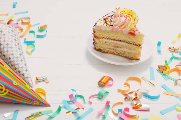 istock birthday cake and  decoration on white wooden background 945574688