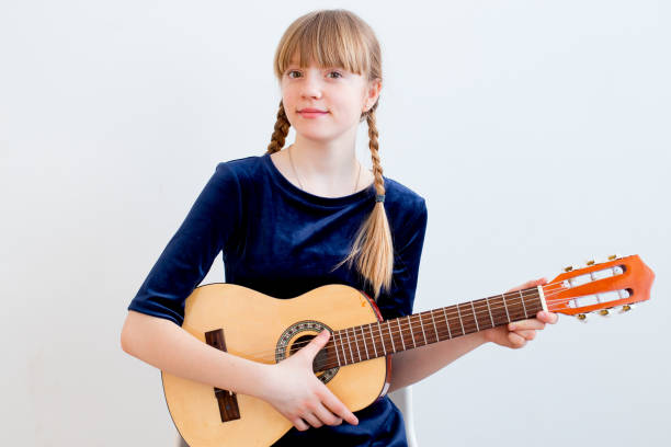 istock Girl playing a guitar 945578946
