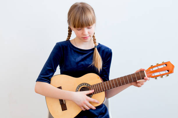 istock Girl playing a guitar 945579008