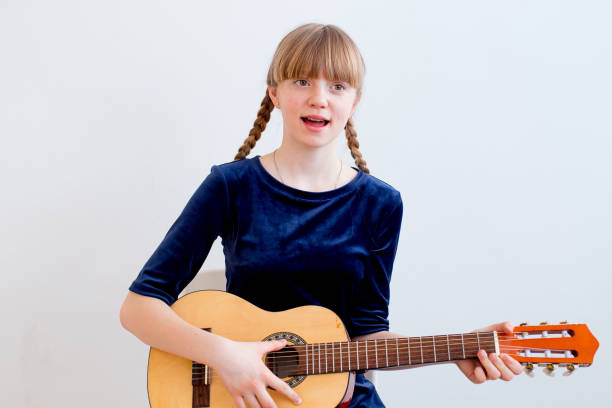 istock Girl playing a guitar 945581108