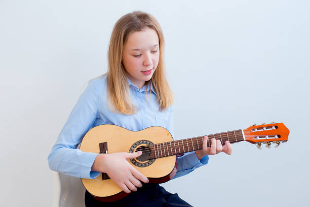 istock Girl playing a guitar 945582072