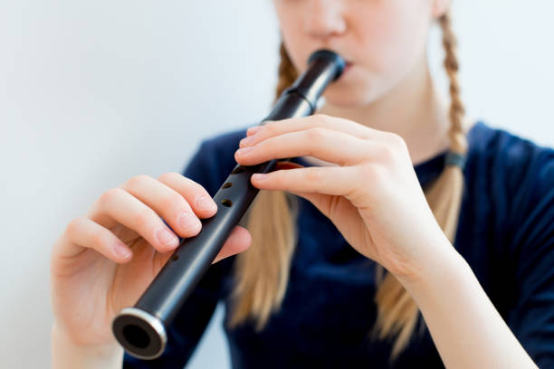 istock Girl playing on a flute 945584322