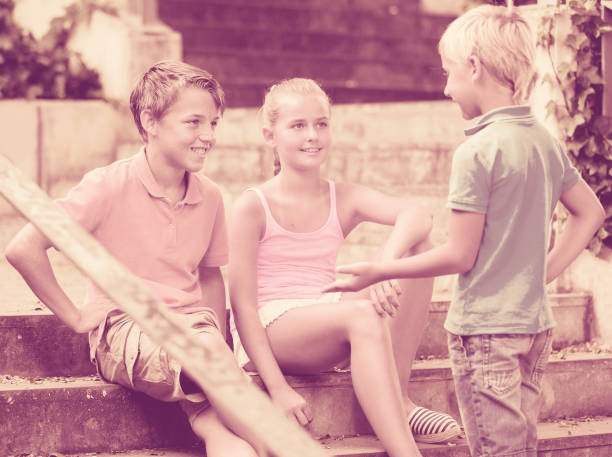 istock Company of children are communicating on walk 945584592