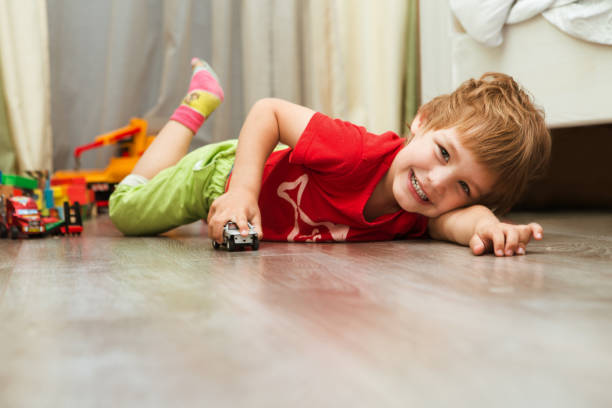 istock little boy plays with toy at home 945589702