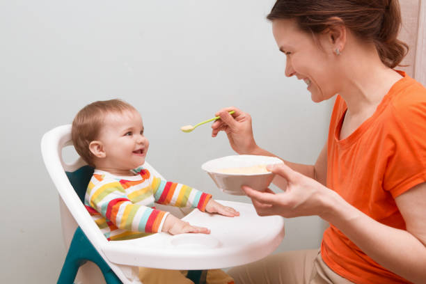 istock Mum spoon-feeds the baby 945592600