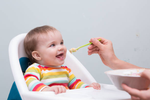 istock Mum spoon-feeds the baby 945592606