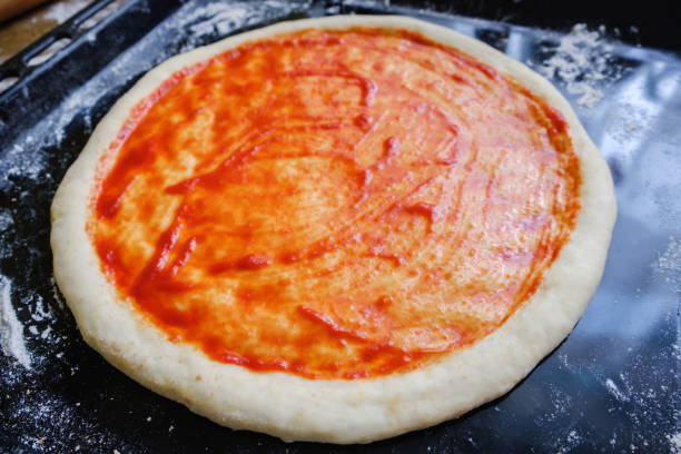 istock Fresh original Italian raw pizza, preparation on a baking tray in the oven 945595592