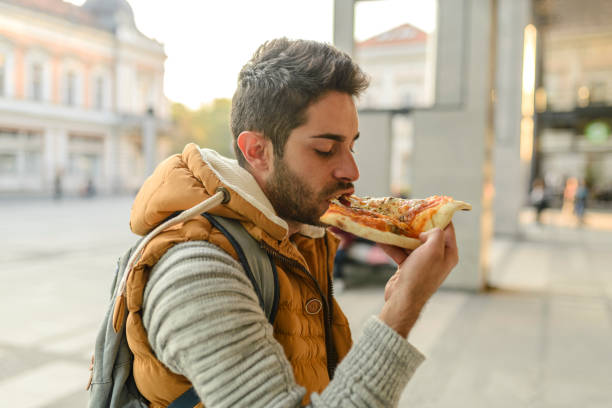 istock Enjoying a slice of pizza 945598618