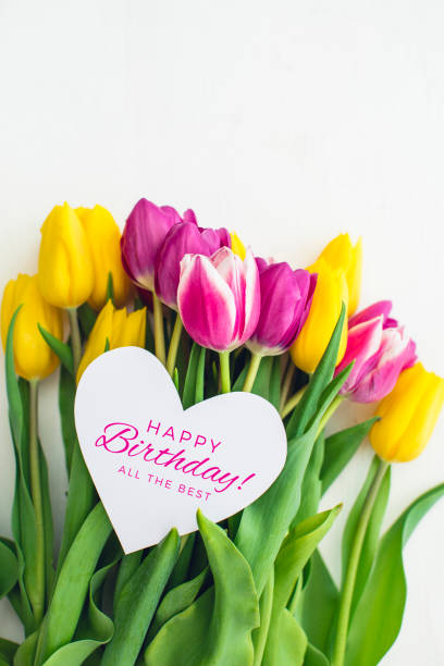 istock Birthday card - Pink and yellow tulips 945603934