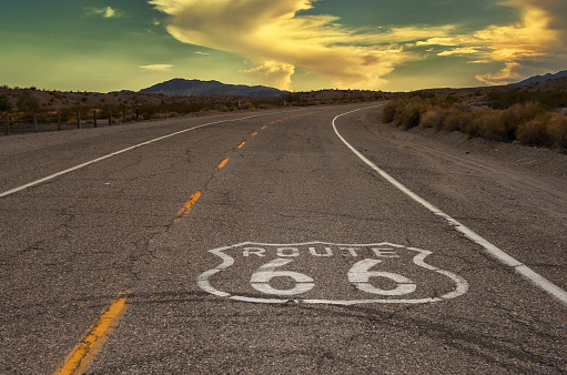Route 66 logo on road that leads into sunset