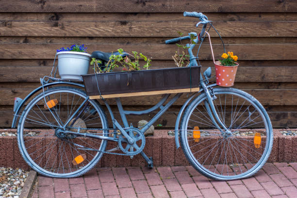 istock Discarded bicycle is used as a flower stand 945605816