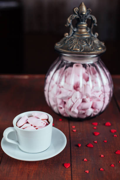 cocoa drink with marshmallows and glass vintage retro jar with pink candy on wooden table - hot chocolate hot drink high section close up imagens e fotografias de stock