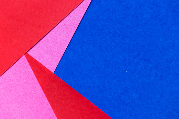 istock Pink, red and blue color paper display as abstract blank background 945609430