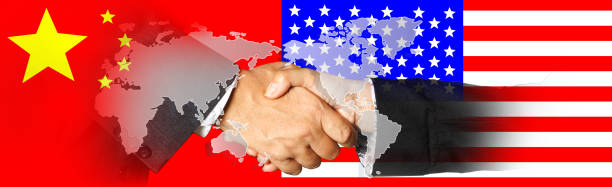 istock China and US flags with a handshake on world map  background 945620480
