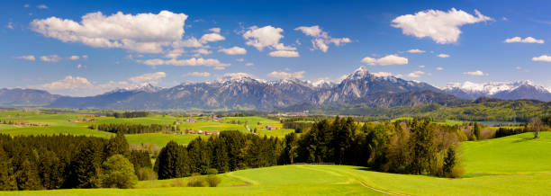 istock panoramic landscape in Bavaria with alps mountain range 945621176