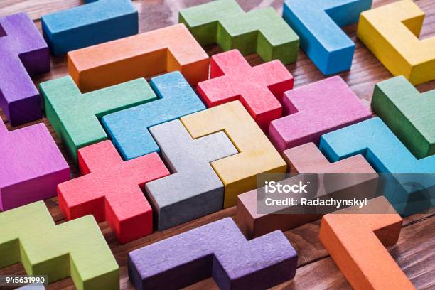 Geometric Shapes On A Wooden Background Stock Photo - Download Image Now - Cooperation, Puzzle, Teamwork