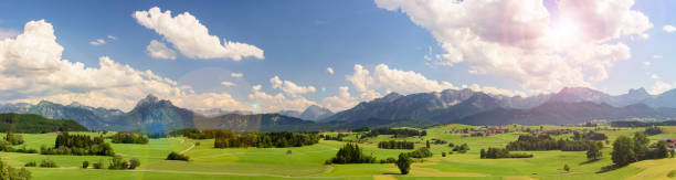 istock panoramic landscape in Bavaria with alps mountain range 945634442