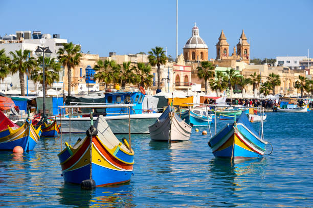 Marsaxlokk harbor Marxaslokk harbor with traditional maltese eyed boats - luzzu on the bright sunny day. malta stock pictures, royalty-free photos & images