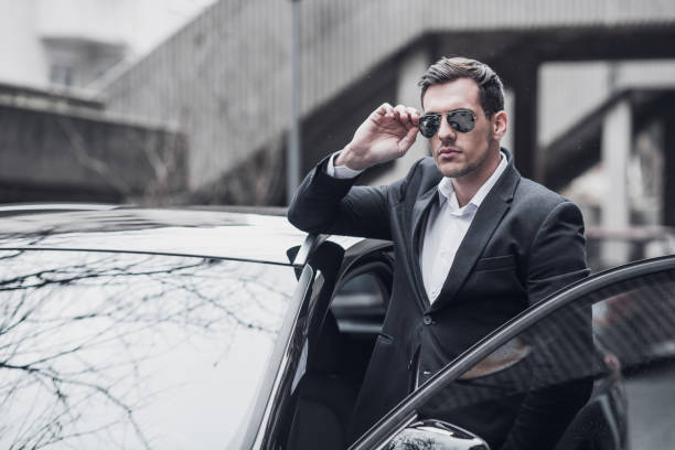 istock Businessman by the business car 945646916