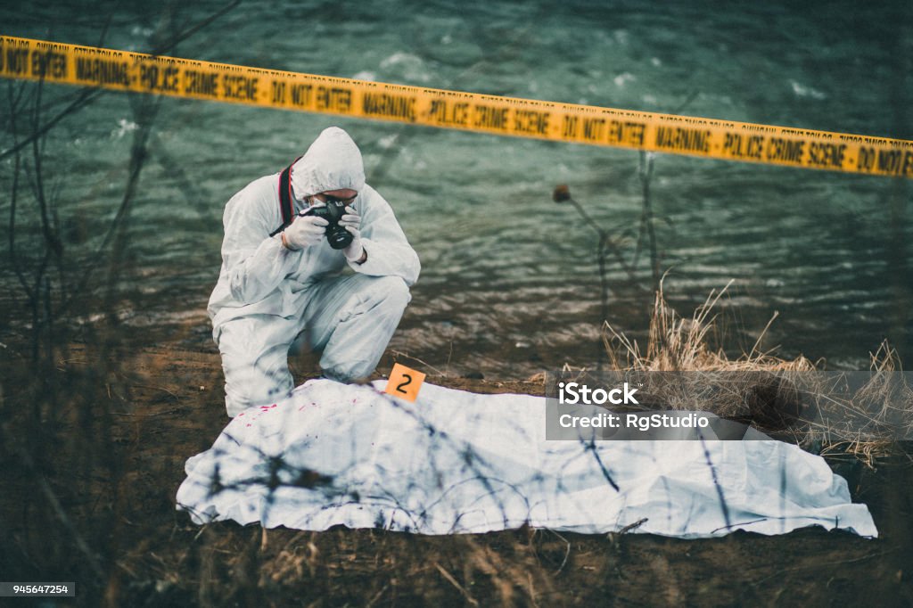 Photographer taking photos of crime scene by the river Photograph on the crime scene Murder Stock Photo