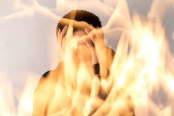 Businessman with burning hair and head making a shocked facial gesture