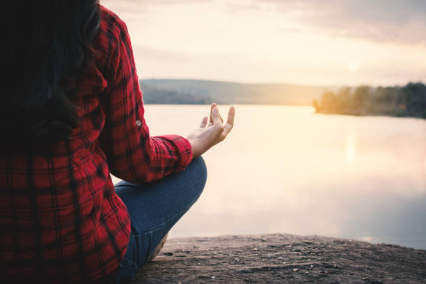 istock Happy Asian woman meditation and relax during sunset 945657430