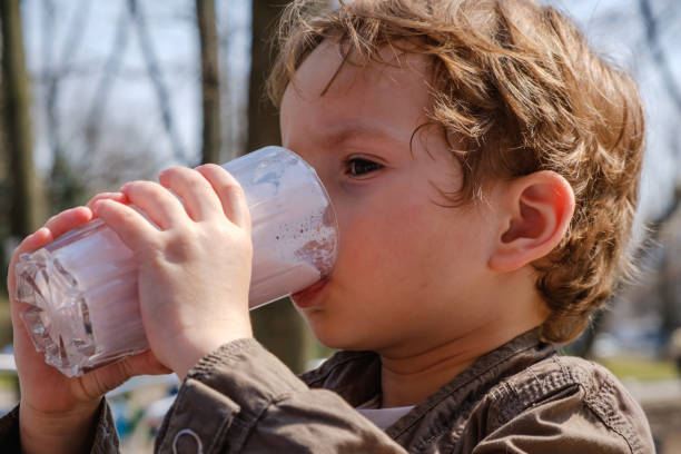 istock Little boy drinking strawberry milkshake 945667152