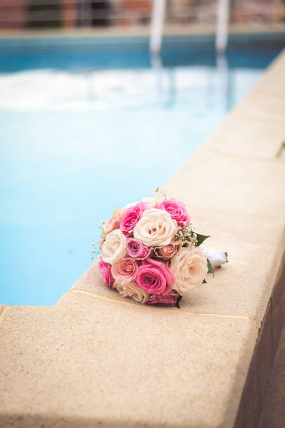 istock Beautiful bridal bouquet next to the pool 945670956