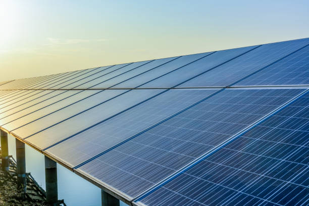 istock Sunset rays over a photovoltaic power plant 945671132