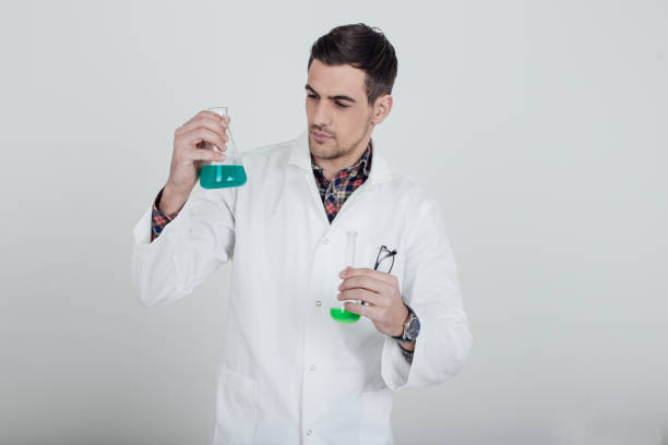 istock Scientist mixing liquids in test tubes 945672150