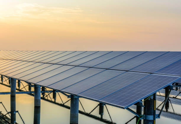 istock Sunset rays over a photovoltaic power plant 945674446