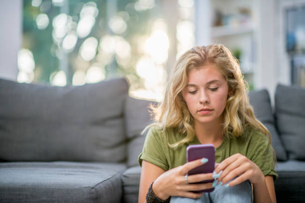 istock Girl Looking At Messages 945674622