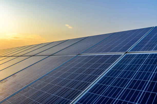 istock Sunset rays over a photovoltaic power plant 945674870