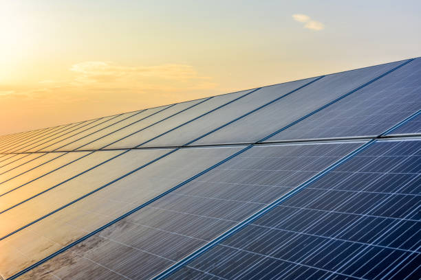 istock Sunset rays over a photovoltaic power plant 945674884