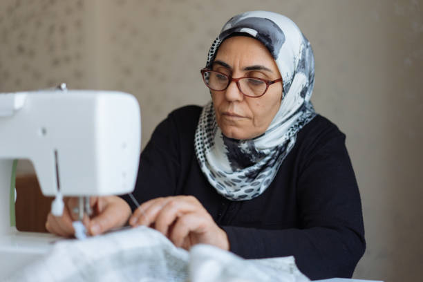 istock Tailor woman working at the sewing machine 945678008