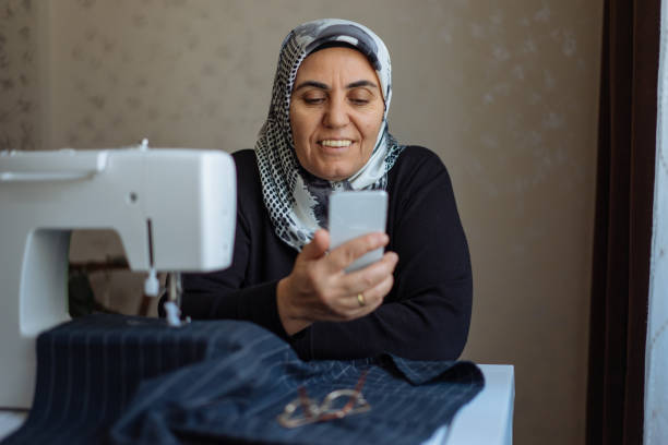 istock Tailor woman working at the sewing machine 945678768