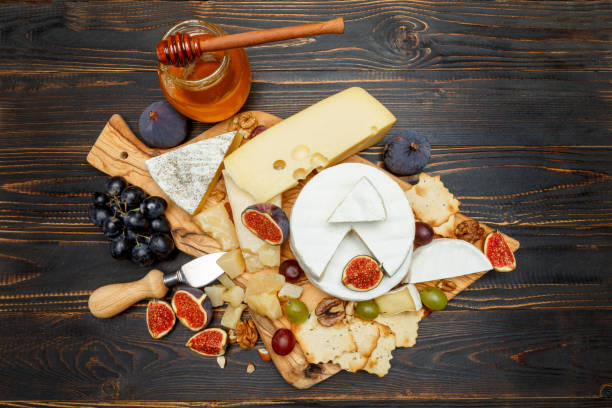 istock Brie cheese on a wooden Board with fresh figs and grapes 945681248