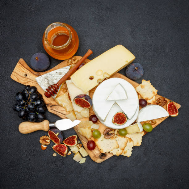 istock Brie cheese on a wooden Board with fresh figs and grapes 945681522