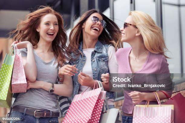 Jovencitas Atractivas Con Bolsas De Compras En La Ciudad Foto de stock y más banco de imágenes de Venta al por menor