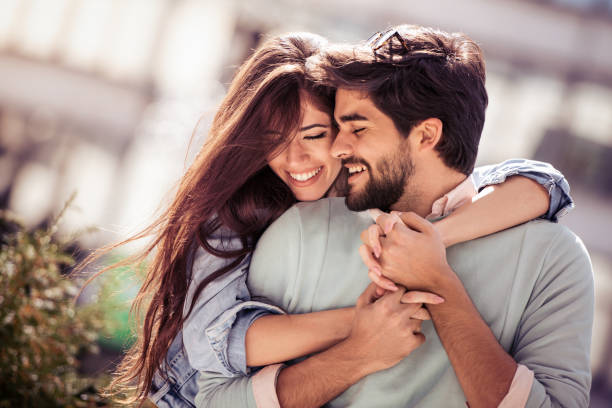 Love, relationship,fun,happiness and romance concept Happy young couple having fun outdoors and smiling. two people embracing stock pictures, royalty-free photos & images