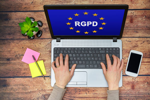 Woman using a computer with Flag of European Union with RGPD word inside on the screen Woman using a computer with Flag of European Union with RGPD word inside on the screen general data protection regulation photos stock pictures, royalty-free photos & images