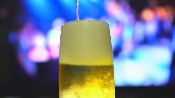 istock Beer is pouring from the top into a pint glass. 945690644