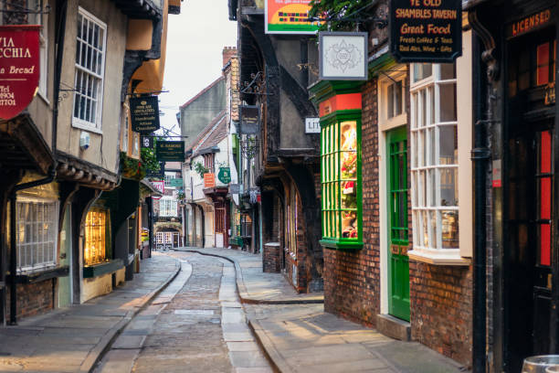 The Shambles in York, England Early morning on the famous narrow medieval street in the historic centre of York, filled with shops, pubs and cafes. christmas chaos stock pictures, royalty-free photos & images